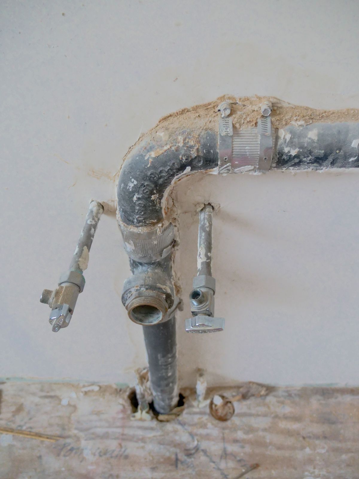 Under-sink plumbing photographed during the inspection